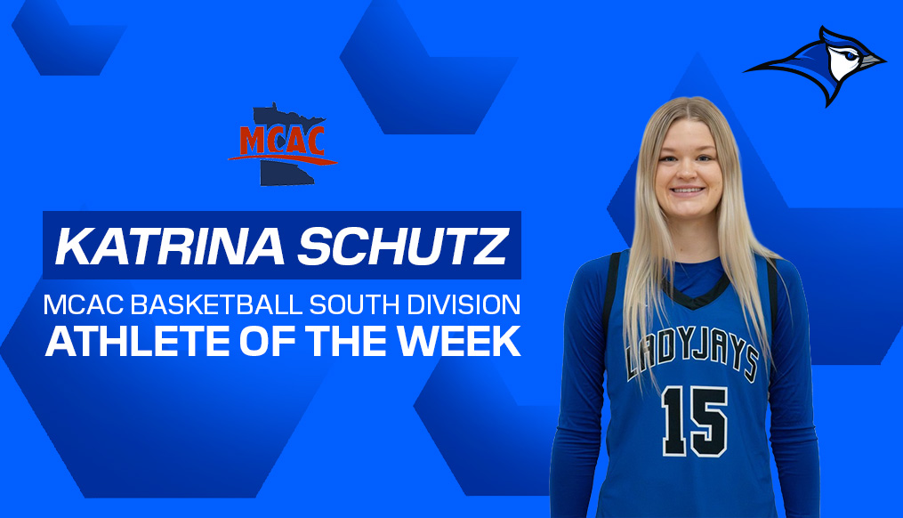 A blue promotional graphic announcing the MCAC Basketball South Division Athlete of the Week. The design features a Katrina Schutz in a blue LadyJays jersey with the number 15, standing on the right side. The left side displays bold white and blue text, along with the MCAC logo. A blue jay mascot logo appears in the upper-right corner.